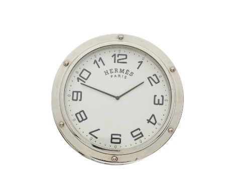 Hermes, a stainless steel Clipper travel clock, featuring a circular white dial, Arabic markers, and brand logo on the revers