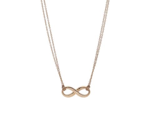 Tiffany &amp; Co., an 18ct gold Infinity pendant, suspended from a two-row trace-link chain, signed Tiffany &amp; Co., hallma