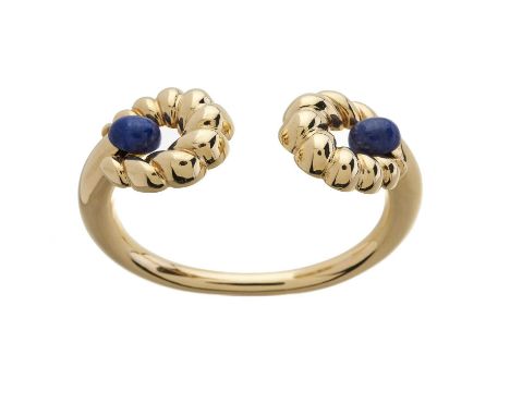 An 18ct gold hinged cuff bangle bracelet, with lapis lazuli cabochon terminals and undulating hinged surrounds, mount stamped