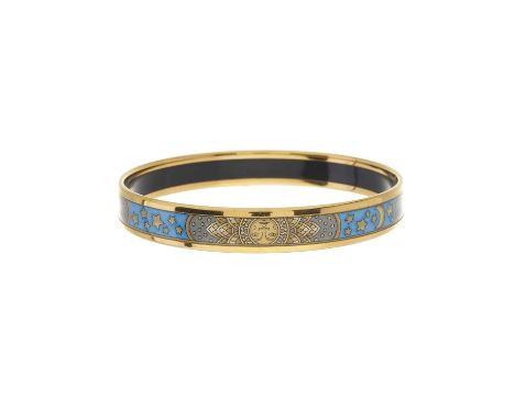 Hermes, an enamel bangle, featuring the sun, moon and stars printed onto blue and grey enamel, with gold-tone edging, signed 