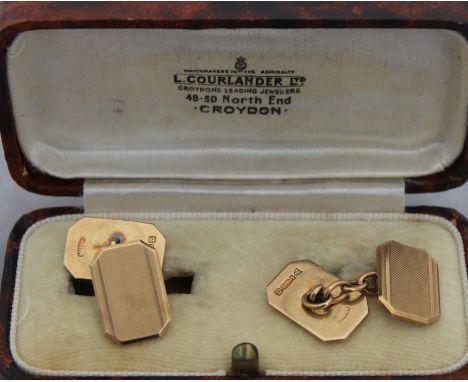 A pair of 9ct. yellow gold rectangular cuff links, having engine turned faces with chamfered corners, chain link, hallmarked 