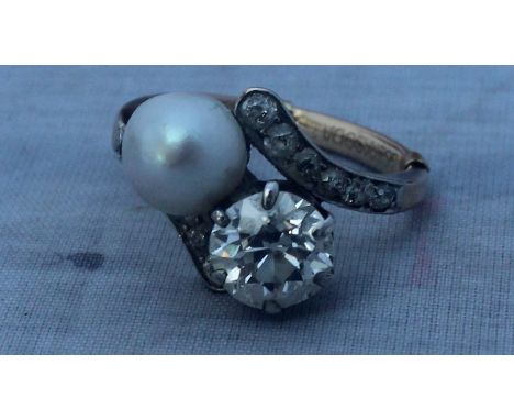 A diamond and pearl cross-over ring, set round brilliant cut diamond (diamond weight approx. 1.65 carats, of good clarity and