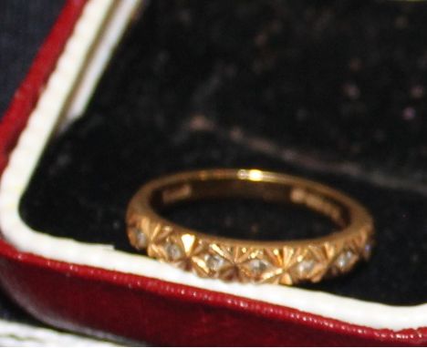 An 18ct. gold and diamond half eternity ring, having engraved half hoop set seven round cut diamonds, shank hallmarked for 18