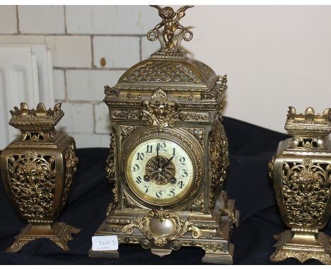 A 19th century gilt brass clock garniture, gong strike, with circular white enamel Arabic numeral dial, height 35cm, (3)