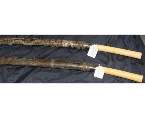 Two 19th century Burmese sword Dha,&nbsp;each having slightly curved single edge blade swollen to tip, silver mounted plain p