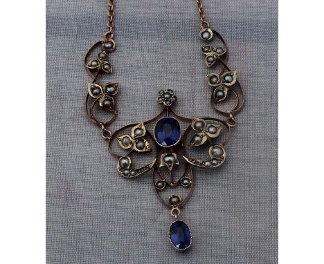 A Belle epoque style precious yellow metal, pearl and sapphire pendant necklace, of typical flower and leaf design, the centr