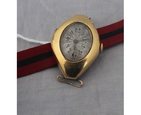 An 18ct. gold ladies' wrist watch, c.1953, manual movement, having engine turned and silvered Arabic numeral oval dial, 23mm 