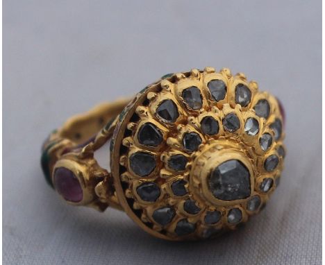 An Indian precious yellow metal, enamel and diamond "poison" ring,&nbsp;having yellow metal shank and mount with red and gree