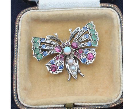 A precious white metal and gem stone set "butterfly" brooch, set round cabochon opal to thorax and three graduated pearls to 