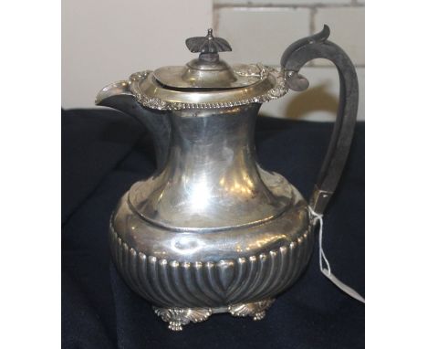 A silver coffee pot, by Reid &amp; Sons, assayed London 1912, of ovoid form, having semi-reeded side, ebony loop handle with 