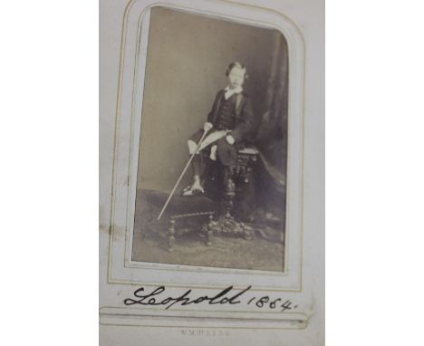 A late 19th century photograph album, having tooled leather boards, the card pages with gilt edges, containing numerous famil