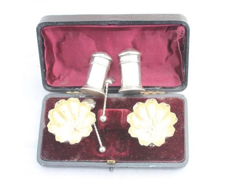 A cased pair of Victoriaan silver circular salts with spoons, by John Milward Banks, Birmingham 1893, the salts of inverted c