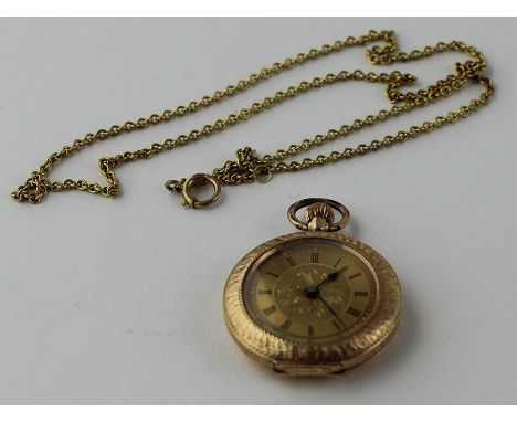 A 14ct. yellow gold ladies' pocket watch, crown wind, having textured gold dial with Roman numeral chapter ring, 30mm diamete