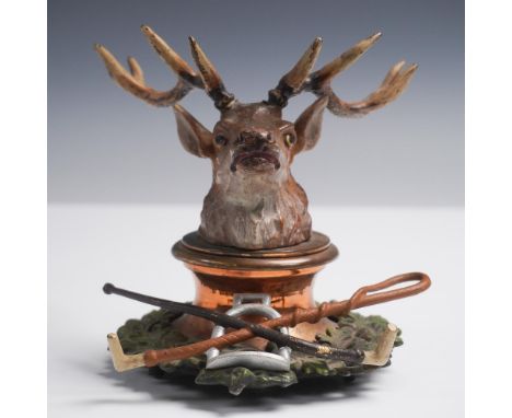 Unusual figural inkwell featuring a detailed stag head that lifts to reveal a copper-lined inkwell beneath. The hinged lid is