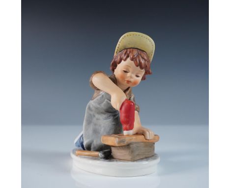 Charming Goebel Hummel porcelain figurine from the Today's Children series, depicting a young boy diligently working on a woo