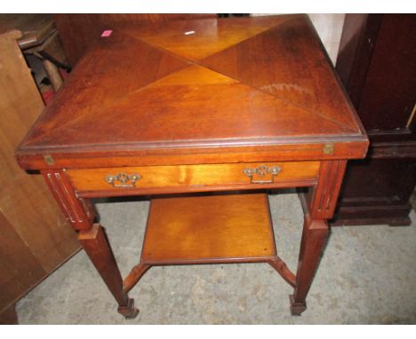 An Edwardian mahogany envelope card table, the swivel top with inset baize, single freeze drawer, square tapering legs with f