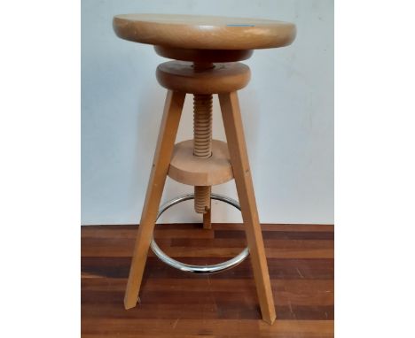 A modern light wooden and chrome adjustable and revolving artists stool. 