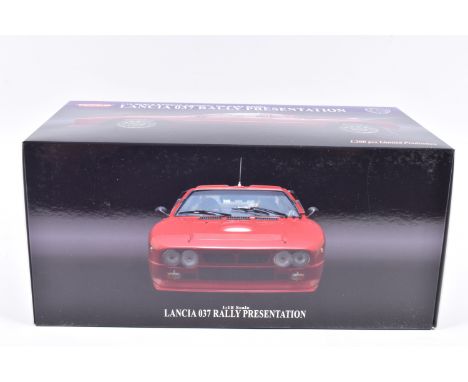 A BOCED KYOSHO LANCIA 037 RALLY PRESENTATION 1:18 SCALE MODEL VEHICLE, numbered 08304R, in red, appears in new condition, add
