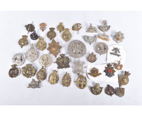 A SELECTION OF MILITARY CAP BADGES FROM DIFFERENT ERAS, these include the 40th second Somersetshire Regiment, 49th Herefordsh