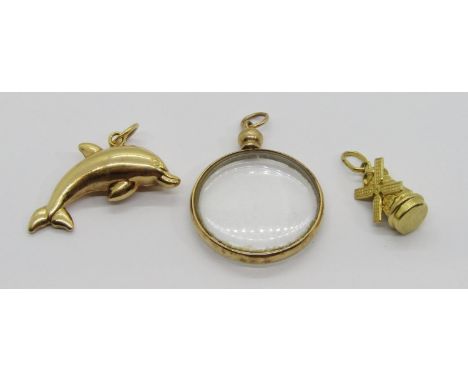 Three vintage 9ct pendants comprising a dolphin pendant, a picture pendant and a windmill pendant / charm, 7.5g gross total (