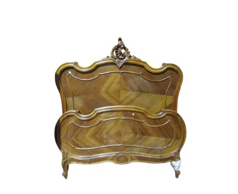 A French walnut bedstead with shaped  outline to accept a 4ft 6" mattress