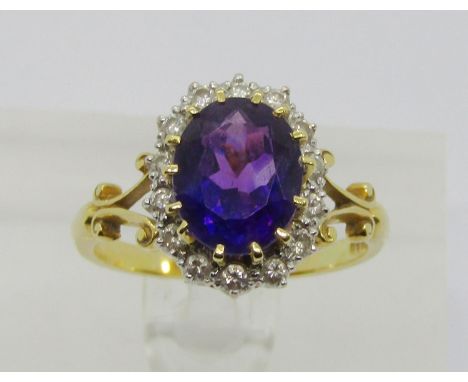 Antique style 18ct claw set oval amethyst and diamond cluster ring with bifurcated shoulders, no makers mark, London 1981, si