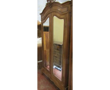 A French walnut single wardrobe with shaped outline enclosed by a pair of mirror plate doors of knockdown construction 240H x