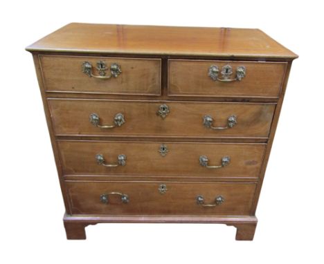 A Georgian mahogany and oak lined chest of two short &amp; three long drawers, with original cast brass fittings, with string