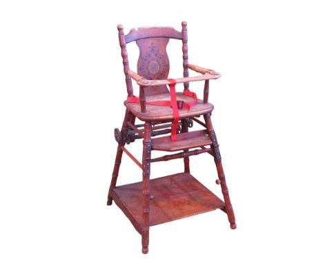 A vintage child's metamorphic highchair with stencilled shaped splat and simulated bamboo supports 