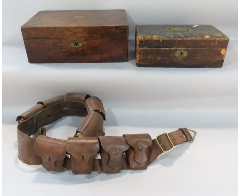 An early 20th century leather nine-pouch ammunition bandolier, together with a mahogany writing slope, a leather lined cash b