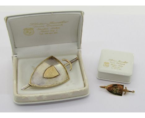 Novelty 14ct bi-colour brooch in the form of a shield and sword with fleur-de-lis detail, 6.8cm L approx, 10.5g and a smaller