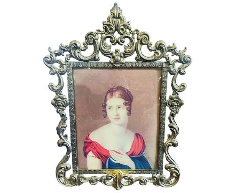 A glazed portrait of a noble woman in a low cut dress, held in a gilded metal frame 28cm x 22cm