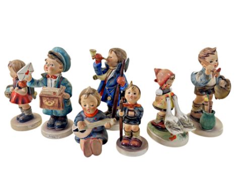 A collection of seven Goebel figures, children in various pursuits