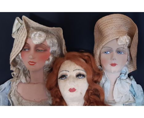 Three 1920's boudoir dolls each with a moulded cloth face, painted features and original period clothes. The red haired doll 