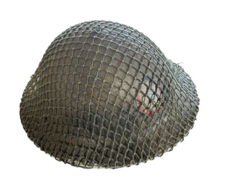 A British Army issue steel helmet with camouflage netting, a pair of goggles, a bayonet, a Soldier’s Bible, two belts and a R