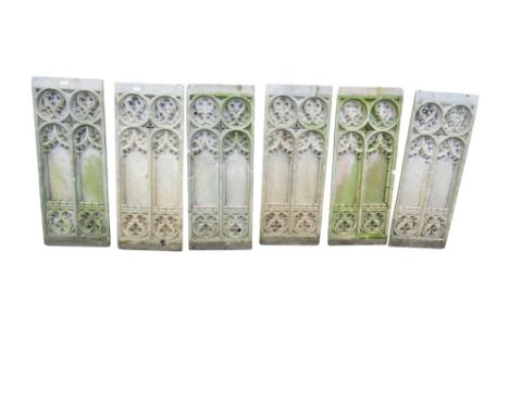 A set of six weathered gothic composition stone panels of rectangular form, moulded with pointed arches, at least one with im