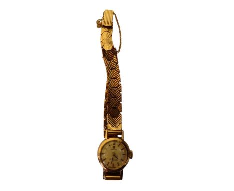Omega. A lady’s vintage ‘Ladymatic’ 9ct yellow gold cased wristwatch, the champagne with baton markers, 16mm case, on a textu