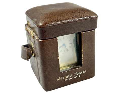 Matthew Norman. A miniature brass cased carriage clock with white enamel dial, 6cm high, in original outer case (displayed be
