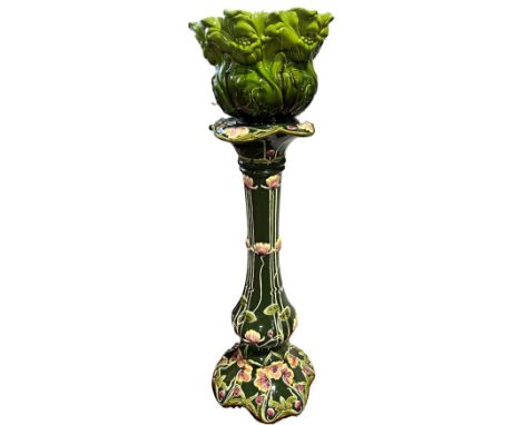 A Bretby green ground jardinière in the Art Nouveau manner, raised on an associated stand with lily detail 108cm H