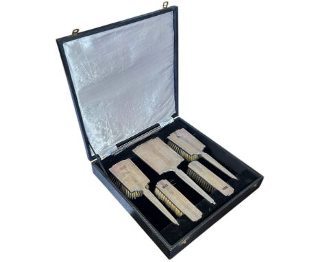 A cased Art Deco style dressing set of six pieces, two hair brushes, two clothes brushes, a mirror and a comb, Birmingham 195