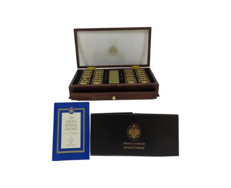 A set of Fabergé Imperial Dominoes, held in a wooden glazed box with a single drawer housing a folded playing mat, complete w