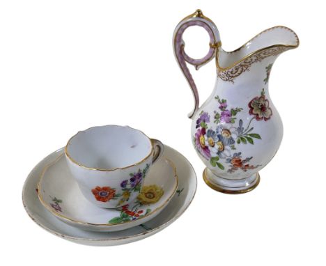 A Dresden wrythen fluted jug with scrolled handle and hand-painted floral detail; a further Meissen cabinet cup and saucer an