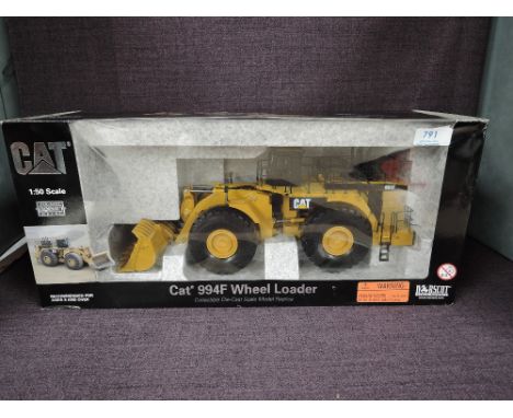 A Norscot 1:50 scale diecast CAT 994F Wheel Loader in yellow in polystyrene packaging and in window display box 55161