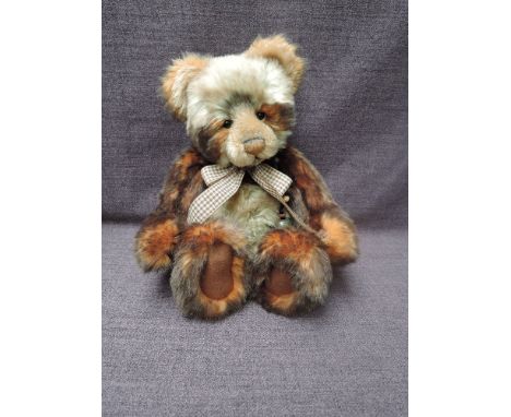 A Charlie Bears Jointed Teddy bear named Tigga having plastic eyes, stitched nose and mouth, two tone brown and cream plush b