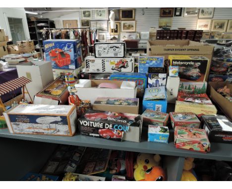 A large colection of reproduction tin plate toys including Space Ship, Motorcycle, Elephant, Hot Air Balloon, Fairground Ride