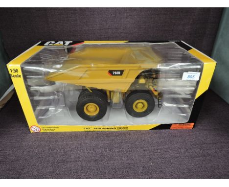 A Norscot 1:50 scale diecast CAT 793D Mining Truck in yellow in plastic packaging and in window display box 55174