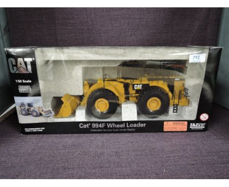 A Norscot 1:50 scale diecast CAT 994F Wheel Loader in yellow in polystyrene packaging and in window display box 55161