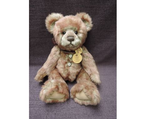 A Charlie Bears Jointed Teddy bear named Scribbles having plastic eyes, stitched nose and mouth, two tone brown plush body an