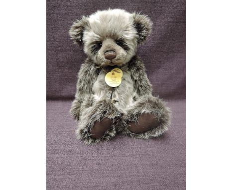 A Charlie Bears Jointed Teddy bear named Walker having plastic eyes, stitched nose and mouth, two tone grey plush body and he