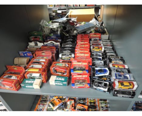 A shelf of modern diecasts including Mattel Cameo, Realtoy Action City, Welly, Tesco Fuel Line etc, all boxed, approx 100